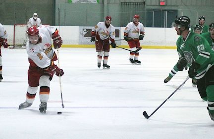 Jake Bruce (L) of the Lancers, gets ready to take a shot, while Alex MacLeod of the Wolves, gets ready to block it